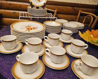 A vintage Sango stoneware dinnerware service set with brown bands and floral motif