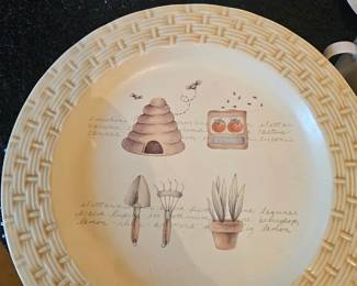 A Sonoma Home garden-themed ceramic dinner plate with a beehive motif.