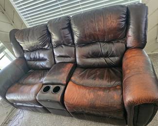 Super comfortable leather couch with drink holder and rocker, recliners. Worn but not cracked. Perfect for a man-cave or game room.