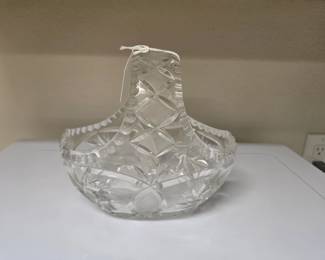 Brighten up your centerpiece collection with this exquisite vintage heavy-cut lead crystal basket. Showcasing traditional European craftsmanship, this piece features brilliant geometric cuts—including deep multi-pointed pinwheel stars and dense diamond cross-hatching—that catch and disperse natural light beautifully. Designed with a sturdy integrated high-arch handle and a stylized notched rim, it makes a gorgeous bridal gift, a classic Easter or spring flower basket, or an elegant holiday candy dish. It is in excellent vintage condition with beautifully preserved clarity and substantial weight.