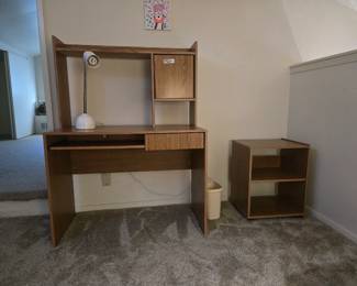  Vintage Compact Student Desk with Hutch & Matching Rolling Cart Set 💻Perfect budget-friendly setup for a student bedroom, dorm, or small home office space! This matching laminate wood-grain set offers excellent vertical storage while maintaining a compact footprint.The Desk & Hutch: Features a built-in top hutch with an open display cubby, a small closed cabinet door, a slide-out keyboard tray, and a convenient lower wire-management slot for electronics.The Rolling Cart: Includes a matching small secondary stand on wheels with two open storage shelves—ideal for a printer, books, or gaming console.Condition: Great, clean condition with no major laminate peeling or sagging. Lightweight and easy to transport!