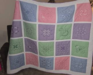 Handmade chicken scratch squares sewn into a quilt