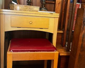 Singer sewing machine in table with foot pedal and stool.