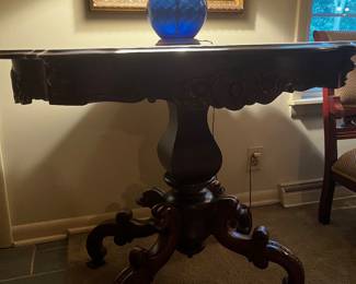 Large antique turtle table with marble top.