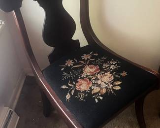Antique chair with needlepoint seat.