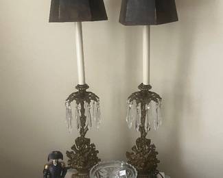 Pair of antique candlestick lamps, wicker side table and glass bowls.