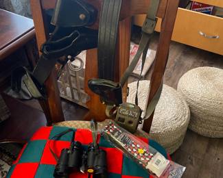 Gun holsters, game camera, binoculars and quilt