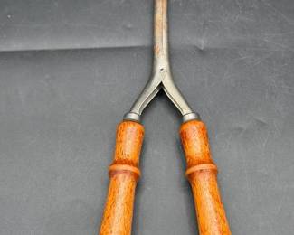 antique, stove-heated metal hair curling iron