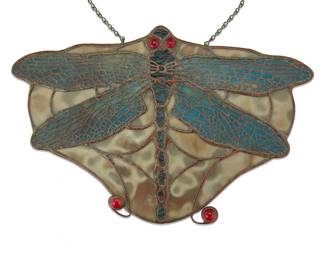 3002 A Tiffany Studios style leaded glass dragonfly lamp screen Late 20th century The wings with metal overlay filigree, with red bead accents to eyes and tail Unmarked Height 6 5/8 in., width 10 1/8 in., depth 1/2 in. Estimate: $400 - $600