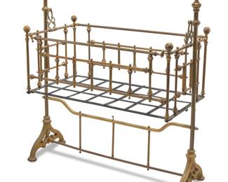 3122 A Victorian brass rocking cradle Late 19th century With tubular spindle construction Height 47 1/2 in., width 46 1/2 in., depth 21 1/2 in. Estimate: $300 - $500
