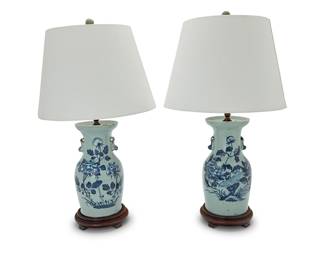 3397 A pair of Chinese blue and white porcelain vases mounted as lamps 20th century Decorated with chrysanthemums and with figural handles, each mounted on a wood base and with single light surmounted by a fabric shade and carved hardstone finial, electrified Each appears unmarked 2 pieces Height of vases 12 3/4 in., diameter 7 in.; height of each lamp 29 in.; height of shades 11 in., diameter 16 1/2 in. Estimate: $400 - $600