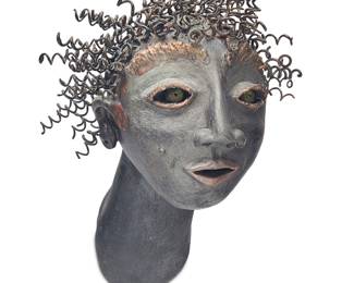 3279 A Postmodern wall sculpture of a woman's head Late 20th century Painted ceramic and metal springs Unmarked Height when mounted 10 in., width 7 1/2 in., depth 7 1/2 in. Estimate: $300 - $500