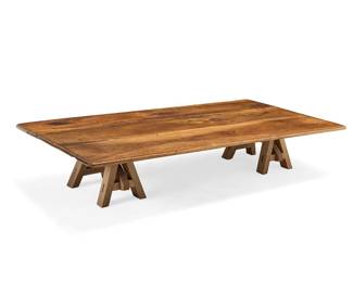 3101 A rustic walnut coffee table 20th century The three-plank top with rounded edge, raised on diminutive sawhorse-style supports Height overall 15 1/4 in., width 80 3/4 in., depth 41 3/4 in. Estimate: $400 - $600