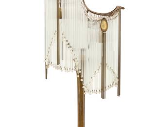 3380 After Hector Guimard (1867-1942) An Art Nouveau table lamp, first half 20th century The patinated metal two-light lamp issuing cascading glass rods and beads, and two peacock-style glass accents issuing metal rods, electrified Height 28 3/4 in., width 14 in., depth 8 3/8 in. Estimate: $600 - $800