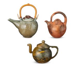 3066 Three studio ceramic teapots Three works: Jan Wax & Chris Bing (20th/21st Century) A celadon glazed teapot with wood handle, 2002 Incised with date to underside: Wax and Bing Height 9 5/8 in., width 8 5/8 in., depth 5 3/4 in. Two teapots, late 20th/early 21st century Comprising one red clay and another carved green hardstone One incised, possibly reading: Dean 2 pieces 3 pieces total Estimate: $200 - $400