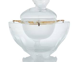 3411 A Lalique glass 'Igor' caviar bowl Late 20th/early 21st century Designed in 1969 by Marie-Claude Lalique (1935-2003) In four pieces, with silver-plated support and frosted glass dolphin-form finial and tripod base Etched: Lalique ® France Height 10 1/8 in., diameter 7 7/8 in. Estimate: $500 - $700