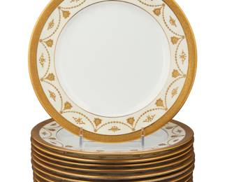 3414 A set of eleven Coalport gilt porcelain dinner plates Early 20th century Each with green stamped factory mark; most marked in gilt: 6867/D; some variously impressed with factory numbers; four centered by a monogram 11 pieces Diameter of each 10 3/8 in. Estimate: $300 - $500