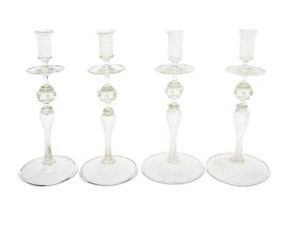 3031 A set of four Murano glass candlesticks Mid-20th century Each unmarked 4 pieces Height of each 12 5/8 in.; diameters 5 3/8-5 5/8 in. Estimate: $400 - $600