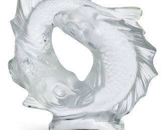 3356 A Lalique glass 'Deux Poissons' centerpiece Late 20th/early 21st century Designed 1953 by Marc Lalique (1900-1977) Depicting two intertwined carp, raised on a circular base Etched: Lalique ® France Height 11 1/2 in., width 10 1/2 in., depth 5 1/2 in. Estimate: $500 - $800