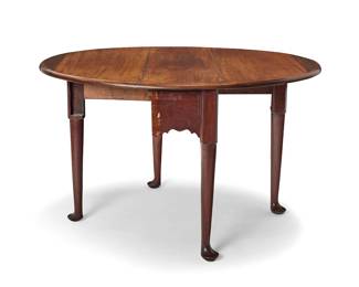 3383 A George III mahogany drop leaf oval table Late 18th/early 19th century With two hinged leaves above a shaped apron, raised on four legs with pad feet Height 27 1/4 in., width 36 in., depth 12 1/2 in.; extended depth 45 3/4 in. Estimate: $400 - $600