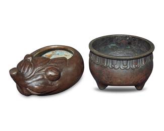 3401 Two Japanese bronze vessels 20th century or earlier Comprising an eggplant-form brush washer and a tripod censer 2 pieces Height of tripod 3 in., diameter 4 3/8 in.; height of eggplant 2 5/8 in., width 6 3/8 in., depth 4 1/4 in. Estimate: $200 - $300