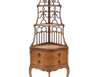 3224 A Louis XV style mixed wood corner étagère 20th century Comprising three shelves with openwork back, above a two-drawer chest, the fronts with foliate inlay, raised on cabriole legs carved with foliate accents at sides and center of apron Height 59 1/2 in., width 21 3/4 in., depth 16 1/2 in. Estimate: $300 - $500
