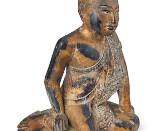 3150 A Burmo-Thai carved giltwood monk 19th/20th century With inset glass accents Height 12 3/8 in., width 9 3/8 in., depth 8 1/2 in. Estimate: $200 - $400