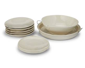 3309 Sandy Simon (b. 1949) A group of eight studio pottery items, late 20th/early 21st century Comprising a set of five 8 in. plates, an 8 in. serving dish, a large platter, and a large bowl, each with set with small metal accent elements Each incised: S Simon 8 pieces Height of large platter without handles 2 in., diameter 13 1/4 in.; height of bowl 4 in., width 11 3/8 in., depth 11 1/8 in. Estimate: $200 - $400
