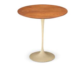 3321 In the manner of Eero Saarinen (1910-1961) A tulip-style side table, late 20th century The circular wood top raised on an enameled steel base Unmarked Height 20 1/4 in., diameter 20 in. Estimate: $200 - $300