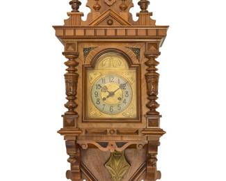 3118 Gustav Becker (1819-1885) A regulator wall clock, late 19th/early 20th century With twin train movement, the silvered dial bearing Arabic numerals, housed in a veneered wood case with turned elements and crenellated cornice Brass back plate of movement marked for Becker Height 43 in., width 17 in., depth 8 1/2 in. Estimate: $300 - $500