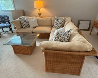 Vintage wicker sectional with coffee table and chair with ottoman. See following picture for chair/ottoman photo. Comes with throw pillows. Very clean and is in good vintage condition. Wicker has broken pieces in back side. More photos for condition available upon request. H- 28. W-34. L- 100 x 100. Coffee table - 32 1/4 square. H- 16 3/4. Chair with ottoman - W- 39 1/4. Seat depth - 22. Price - $ 580.00