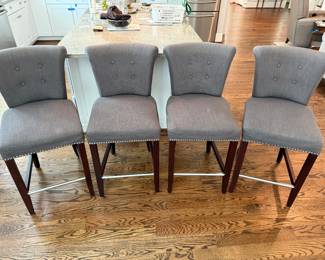 Set of four counterstools with silver nailhead and glam ring pull. Seat bottoms show some minor stains. H- 39. W -18. Seat Height - 24 1/2. See next picture for back of counter stool. Price -$ 280.00