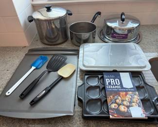 Pots and pans set - Revere ware Dutch oven, Revere ware 3 qt stock pot, Everedy cake toter, 1 rectangle lidded cake pan, 2 Sur La Table shrimp/scallop pans, 2 Chef mate cookie sheets and 3 spatulas.Price - $26.00