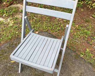 112 graywoodenfoldingchairinthemidcen