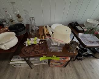 kitchen tools, wooden rolling pins, a white mixing bowl set, and various small household appliances
