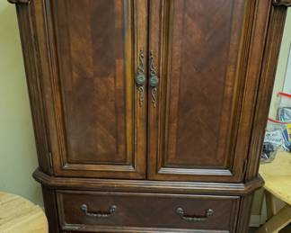 traditional wood armoire and storage cabinet (feature-packed, tall armoire in a rich, dark mahogany-and-cherry finish with reverse-diamond door veneers, scrolled moldings, and two spacious lower drawers)