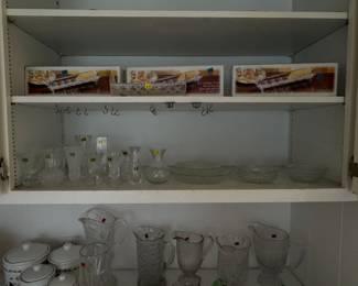 boxed glass cracker dishes, small clear glass bud vases, small glass dishes, and glass pitchers
