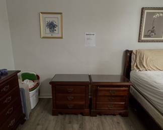 traditional dark wood matching three-drawer nightstands with glass top inserts