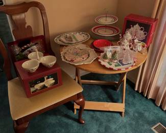 Queen Anne style dining chair with Christmas holiday decor, including a snowman tin, tree-shaped salt and pepper shakers, tiered serving trays, and holiday tableware