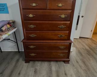traditional wooden tall chest of drawers featuring brass bail handle hardware and a stacked double dresser configuration