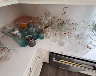 vintage blue Ball jars with zinc lids, clear mason and jelly jars in assorted sizes, half-gallon jars, large glass jar, Pyrex measuring cup, and glass mixing bowls