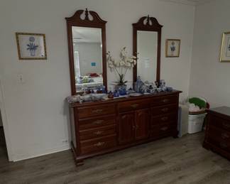 long double dresser with dual attached upright mirrors and blue and white ceramic decor