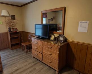 A. Brandt Ranch Oak wooden dresser with an attached mirror, situated next to an A. Brandt Ranch Oak wooden side chair and A. Brandt Ranch Oak small bookcase