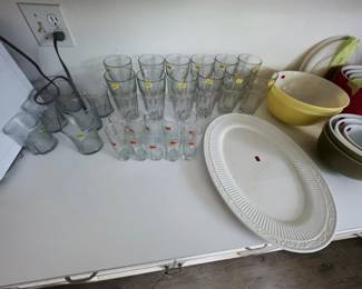 clear glass tumblers, juice glasses, and rocks glasses, plus a white embossed oval platter