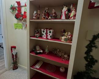 Christmas decorations and figurines, including Santa Claus figures, a decorative gift box, and holiday accessories