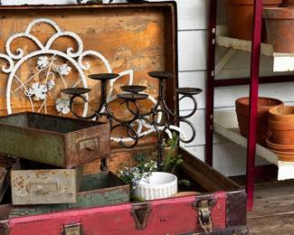 Red trunk, metal bins, candelabras, flower pots