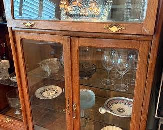 Unique, solid wood and glass-front lawyer-style top display case. It includes distinctive brass accent handles.