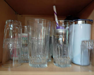 Lot 182: Assorted Glassware, Serving Trays, and Travel Mugs