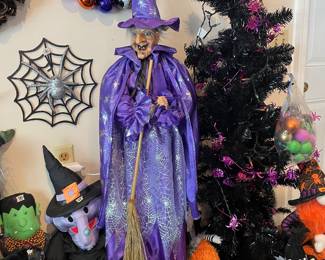 Witch doll with red glowing eyes and cackle
