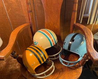 Very nice chair and vintage football helmets